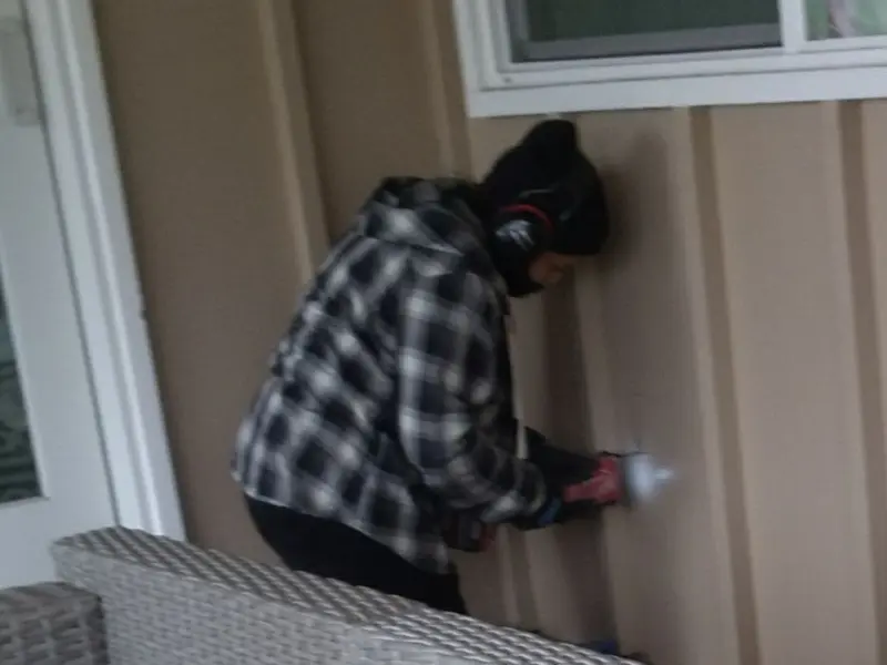Professional electrician installing an exterior outlet in River Edge